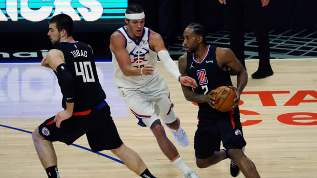 Apr 1, 2021; Los Angeles, California, USA; Los Angeles Clippers forward Kawhi Leonard (2) moves the ball as center Ivica Zubac (40) provides coverage against Denver Nuggets forward Aaron Gordon (50) during the first half at Staples Center. Mandatory Credit: Gary A. Vasquez-USA TODAY Sports